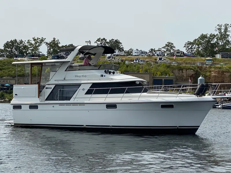 Slide: The Image of 1986 Carver 4207MY yacht on the water with scenic background. - 8