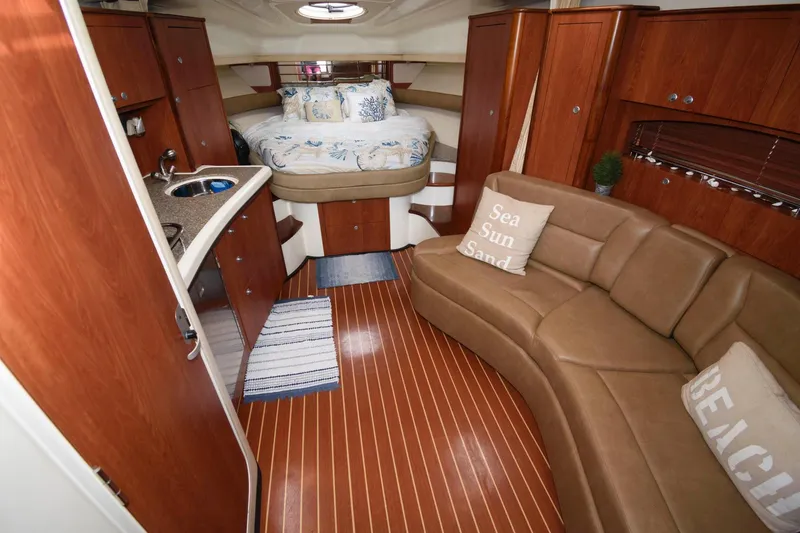 Slide: The Image of 2009 Monterey 340 Sport Yacht interior with bed, kitchenette, and leather seating. - 11