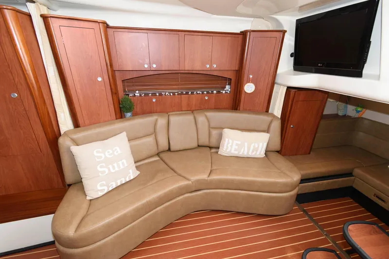 Slide: The Image of Luxurious interior of 2009 Monterey 340 Sport Yacht with curved leather sofa and wooden cabinetry. - 12