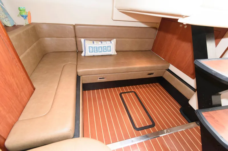 Slide: The Image of 2009 Monterey 340 Sport Yacht interior with tan seating and wood flooring. - 15
