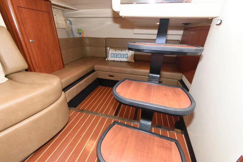 Slide: The Image of Interior of 2009 Monterey 340 Sport Yacht with wooden steps and beige seating. - 16