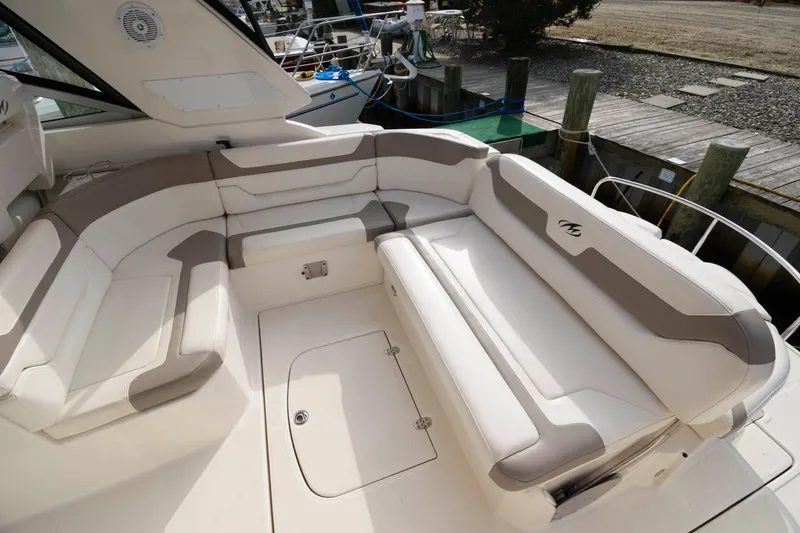 Slide: The Image of 2009 Monterey 340 Sport Yacht spacious seating area with white and beige upholstery. - 3