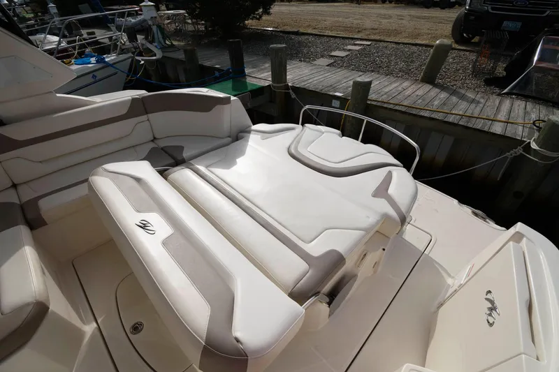 Slide: The Image of 2009 Monterey 340 Sport Yacht rear seating area with white and beige upholstery. - 4