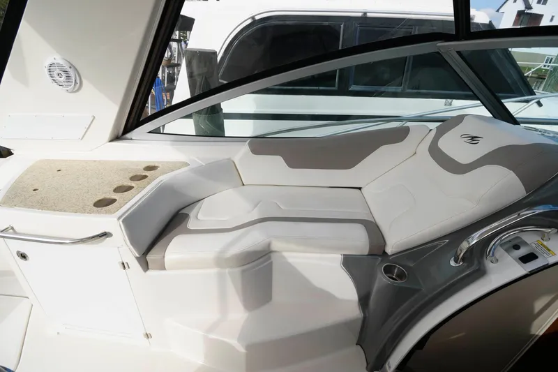 Slide: The Image of 2009 Monterey 340 Sport Yacht interior seating area with white and gray upholstery. - 6