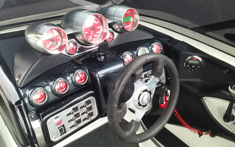 Slide: The Image of 2006 MasterCraft X-Star SS dashboard with red gauges and steering wheel. - 14