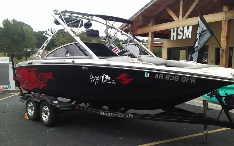 Slide: The Image of 2006 MasterCraft X-Star SS boat on a trailer in a parking lot. - 5