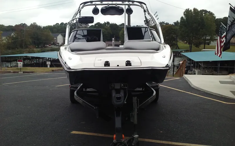 Slide: The Image of 2006 MasterCraft X-Star SS boat on trailer, front view, parked near marina. - 6