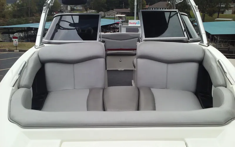 Slide: The Image of 2006 MasterCraft X-Star SS boat with gray seating and open deck. - 8