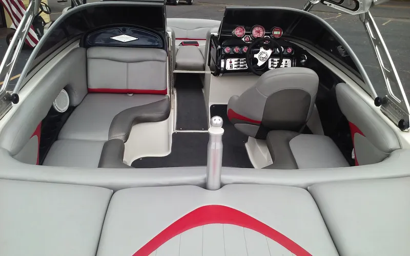 Slide: The Image of 2006 MasterCraft X-Star SS boat interior with gray and red seating, dashboard, and controls. - 9