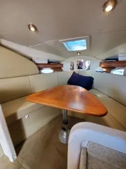 Slide: The Image of 2006 Rinker 300 Express Cruiser cabin with dining area and skylight. - 15