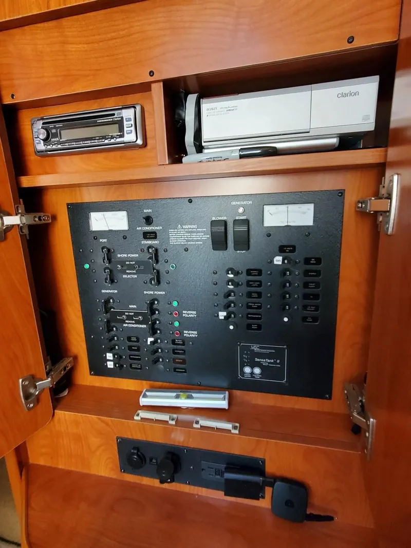 Slide: The Image of Control panel inside 2006 Rinker 300 Express Cruiser with electronic equipment and switches. - 20