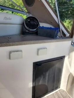 Slide: The Image of 2006 Rinker 300 Express Cruiser interior with dashboard and storage compartment. - 4