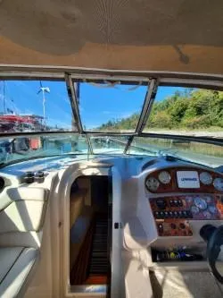 Slide: The Image of 2006 Rinker 300 Express Cruiser cockpit with dashboard and open water view. - 9