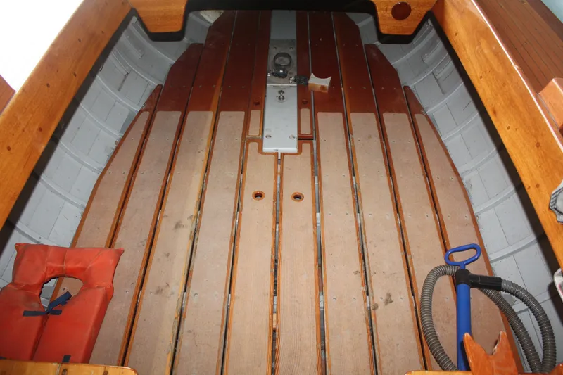 Slide: The Image of 1934 Custom Northern Michigan NM boat interior with wooden floor and safety equipment. - 17