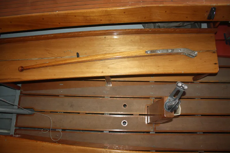 Slide: The Image of 1934 Custom Northern Michigan NM wooden boat interior with tiller and rigging. - 26