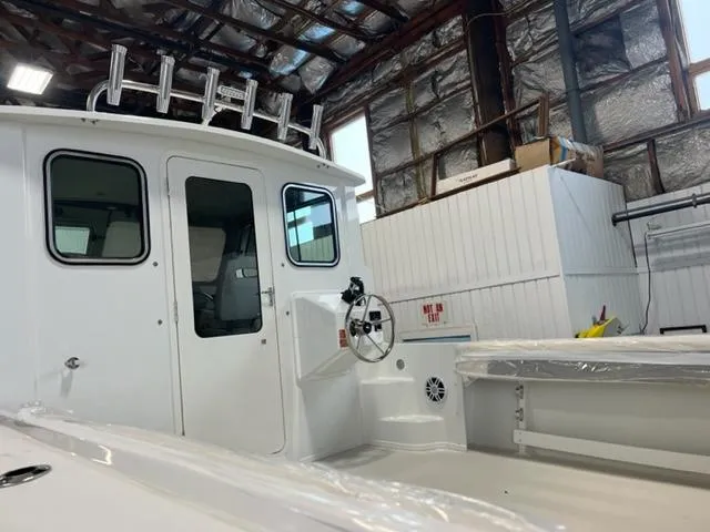Slide: The Image of 2024 Parker 2520 XLD Sport Cabin boat interior in a warehouse. - 15
