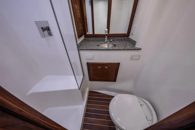 Slide: The Image of 2024 Albemarle Spencer Edition yacht bathroom with modern fixtures and wooden accents. - 22