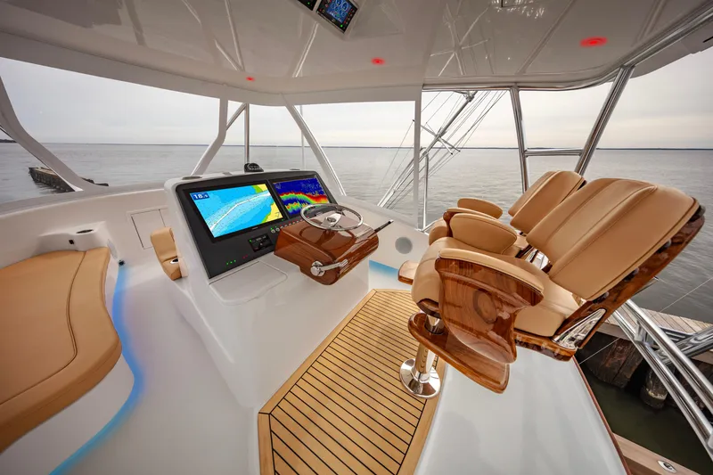 Slide: The Image of 2024 Albemarle Spencer Edition yacht helm with advanced navigation system and luxurious seating. - 6