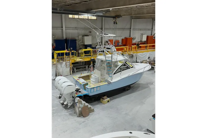 Slide: The Image of 2026 Albemarle 30 Express boat in a workshop, featuring dual outboard engines. - 3