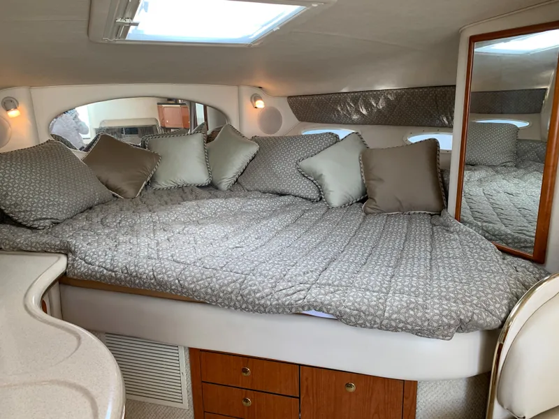 Slide: The Image of Luxurious cabin interior of 2001 Sea Ray 310 Sundancer yacht with cozy bedding. - 14