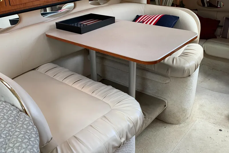 Slide: The Image of Interior of 2001 Sea Ray 310 Sundancer with cozy seating and table. - 17