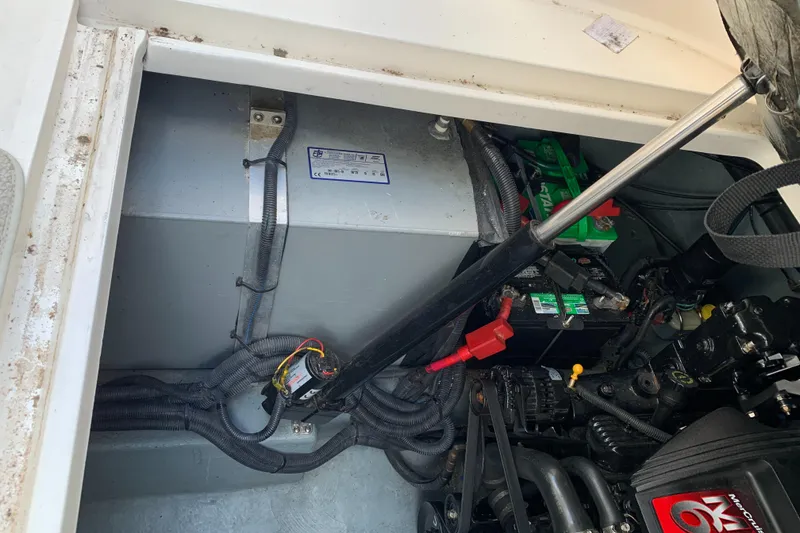 Slide: The Image of Engine compartment of 2001 Sea Ray 310 Sundancer with visible wiring and battery. - 28