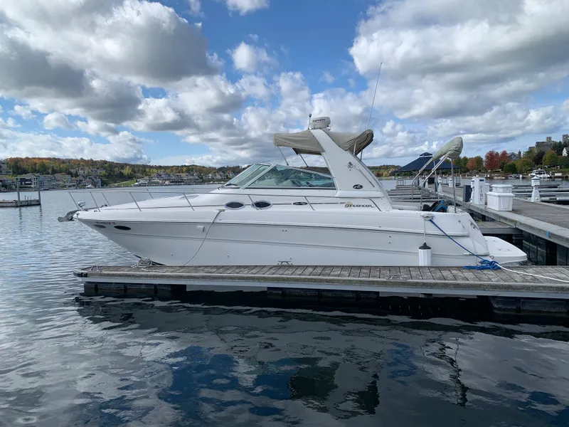 Slide: The Image of 2001 Sea Ray 310 Sundancer docked at a marina under cloudy skies. - 30