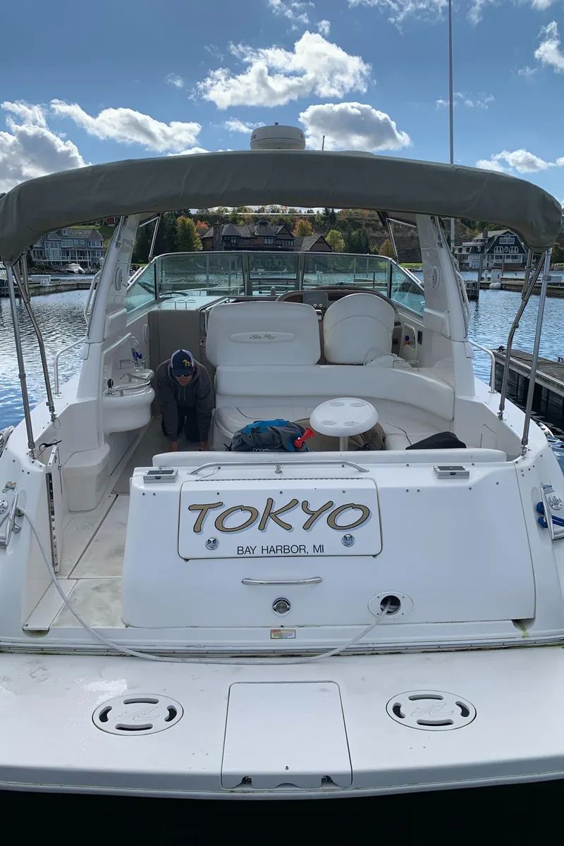 Slide: The Image of 2001 Sea Ray 310 Sundancer boat docked, featuring spacious seating and "Tokyo" nameplate. - 5