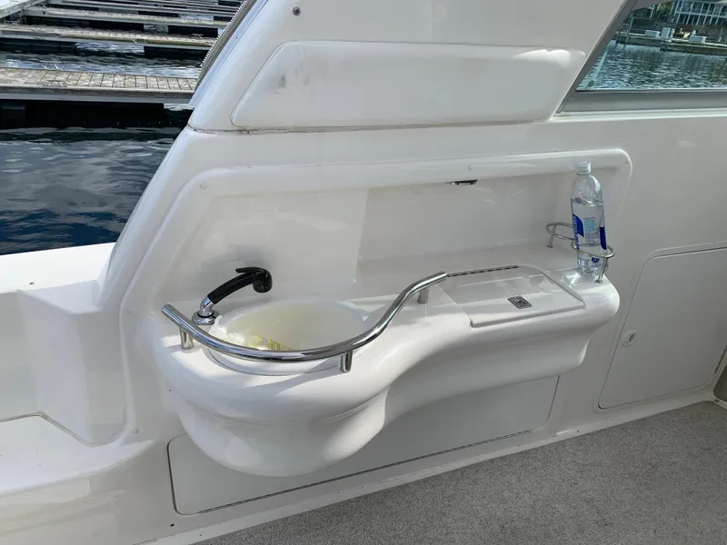 Slide: The Image of 2001 Sea Ray 310 Sundancer boat sink with faucet and bottle holder. - 6