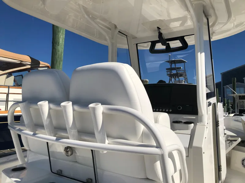 Slide: The Image of 2022 Regulator 26XO boat interior with white seating and rod holders. - 13