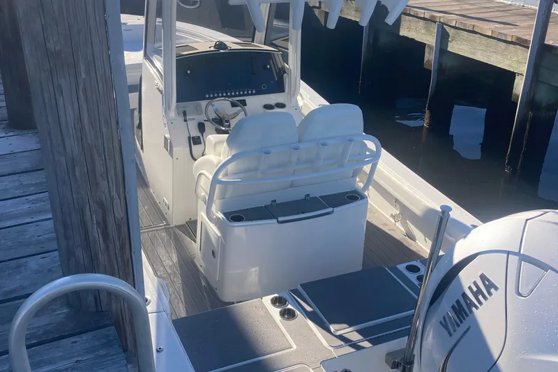 Slide: The Image of 2022 Regulator 26XO boat with Yamaha engine, docked at a marina. - 18