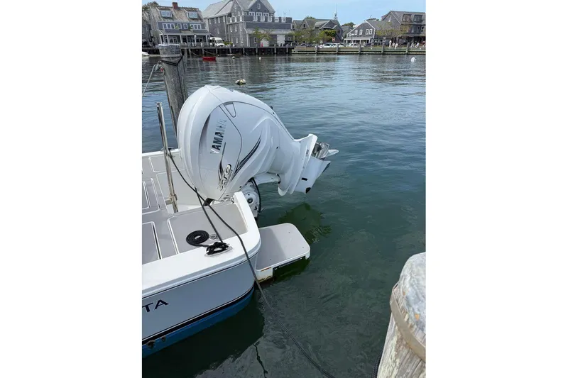 Slide: The Image of 2022 Regulator 26XO boat with Yamaha outboard engine docked in a marina. - 27