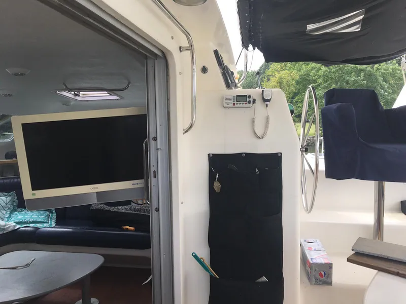 Slide: The Image of Interior of a 1996 Voyage Yachts 470, featuring a TV, seating, and navigation equipment. - 10