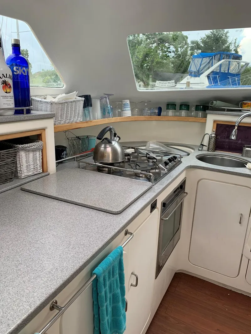 Slide: The Image of 1996 Voyage Yachts 470 kitchen with stove, sink, and countertop. - 12