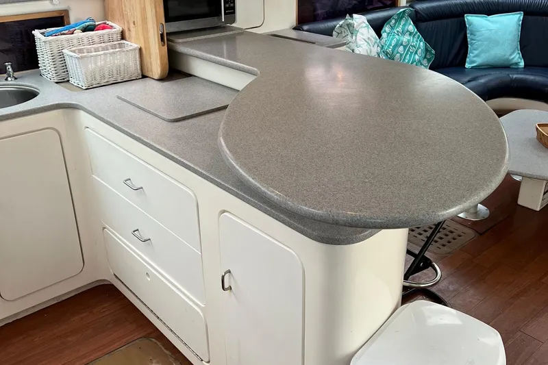 Slide: The Image of Modern kitchen area in a 1996 Voyage Yachts 470, featuring sleek countertops and ample storage. - 16