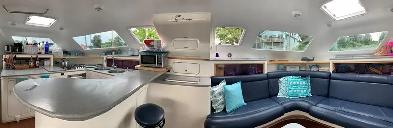 Slide: The Image of Interior of 1996 Voyage Yachts 470 with kitchen and seating area. - 19
