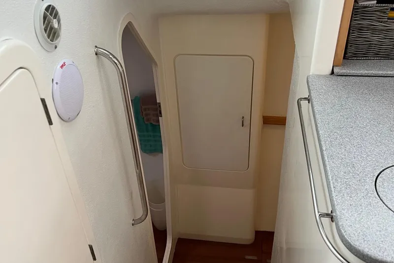 Slide: The Image of Interior of 1996 Voyage Yachts 470, showing hallway and door to bathroom. - 25