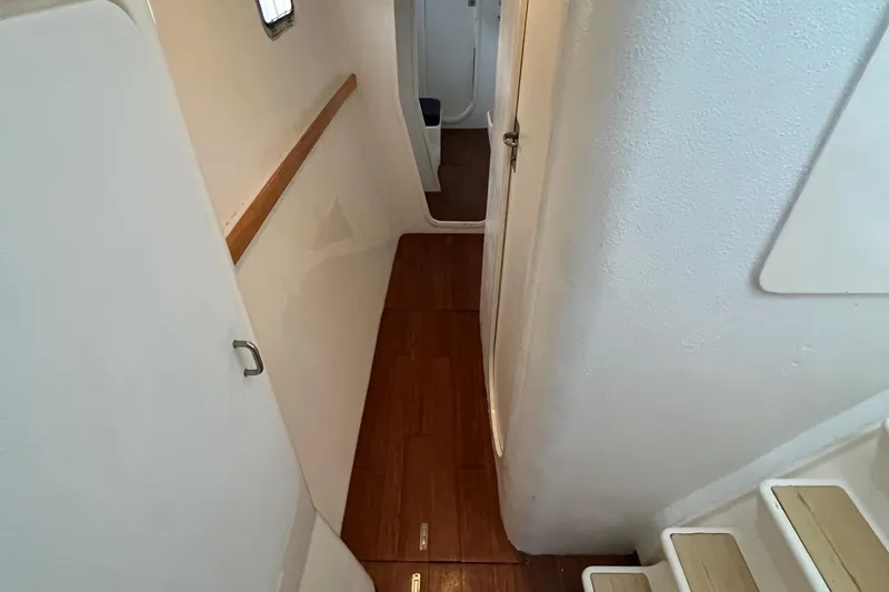 Slide: The Image of Interior hallway of 1996 Voyage Yachts 470 with wooden flooring and white walls. - 26