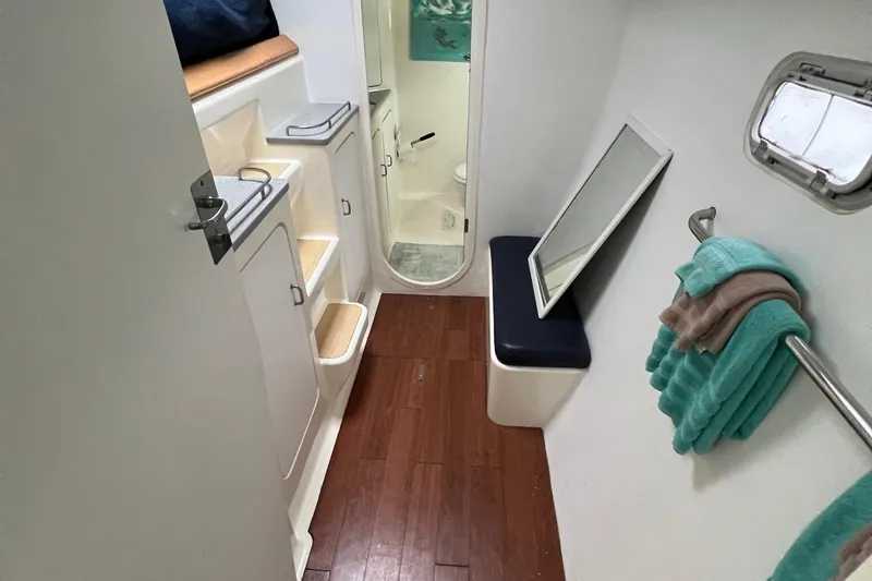 Slide: The Image of Interior of 1996 Voyage Yachts 470 with wooden flooring and bathroom view. - 27