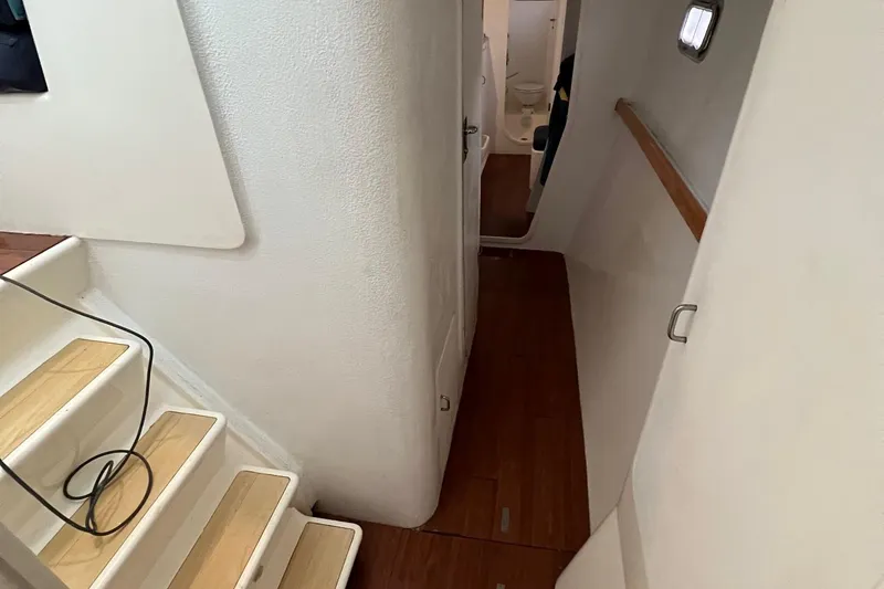 Slide: The Image of Interior hallway of 1996 Voyage Yachts 470 with wooden flooring and white walls. - 29