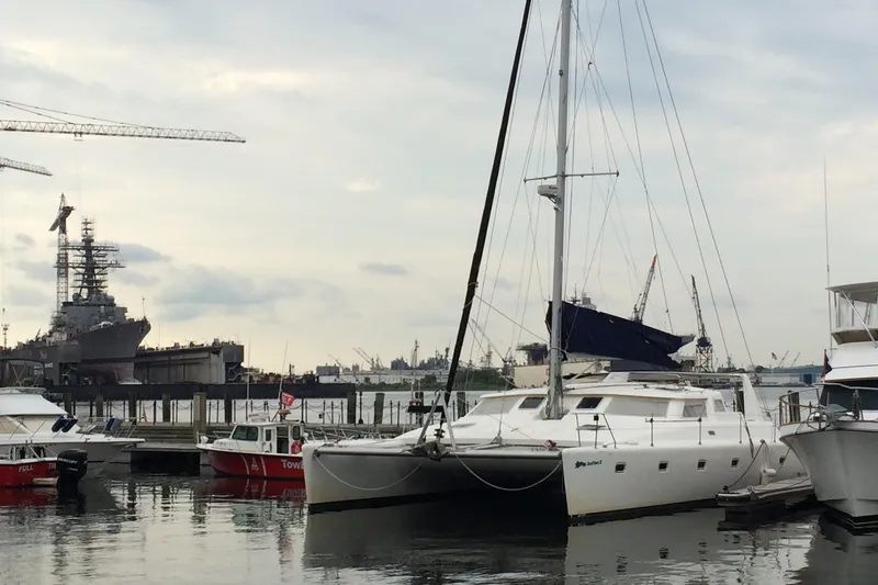 Slide: The Image of Voyage Yachts 470 catamaran docked at a marina, 1996 model. - 3