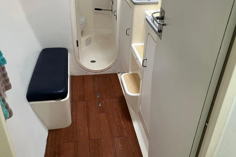 Slide: The Image of Interior of 1996 Voyage Yachts 470 with wooden flooring and compact bathroom. - 30