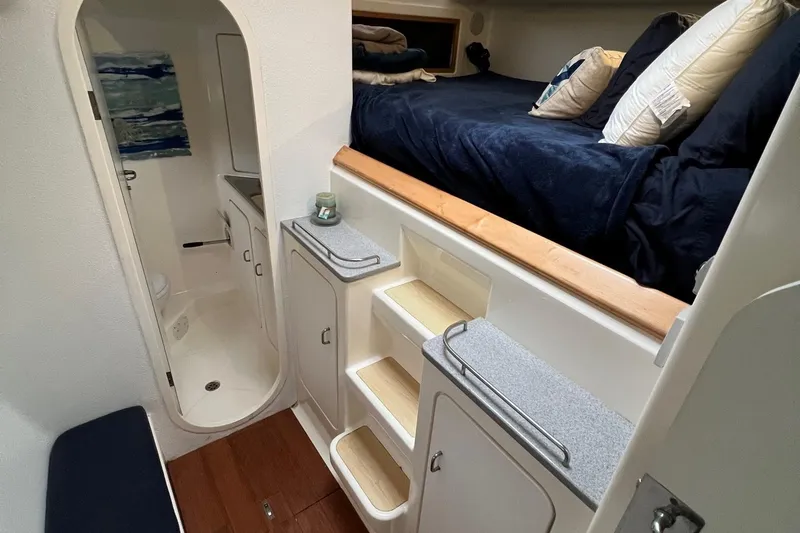 Slide: The Image of Interior cabin of 1996 Voyage Yachts 470 with bed, storage, and bathroom. - 35