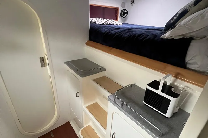Slide: The Image of Interior cabin of 1996 Voyage Yachts 470 with bed, steps, and compact air conditioner. - 36