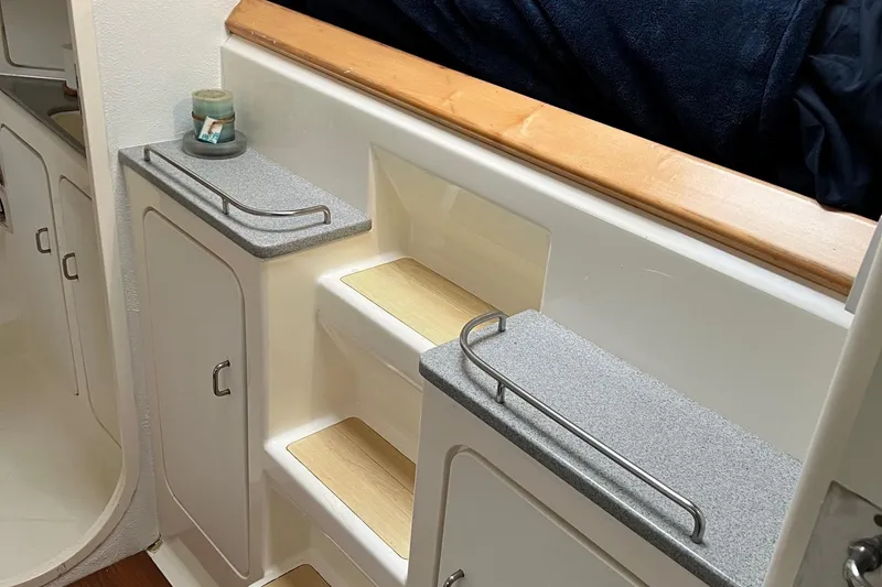 Slide: The Image of Interior stairs and storage cabinets on a 1996 Voyage Yachts 470 sailboat. - 38