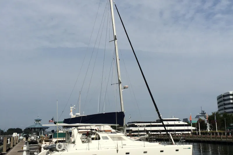Slide: The Image of Voyage Yachts 470 catamaran docked at a marina, 1996 model. - 4