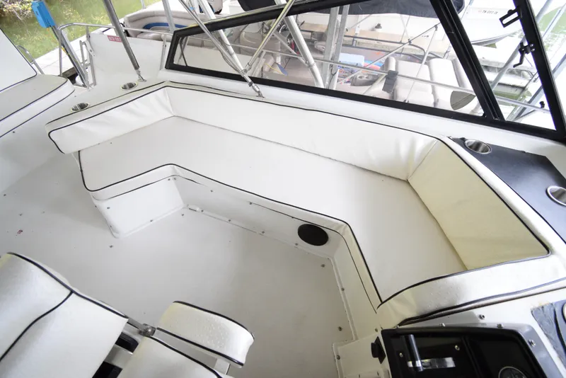 Slide: The Image of 1989 Carver 32 Mariner boat interior with white seating and black trim. - 10