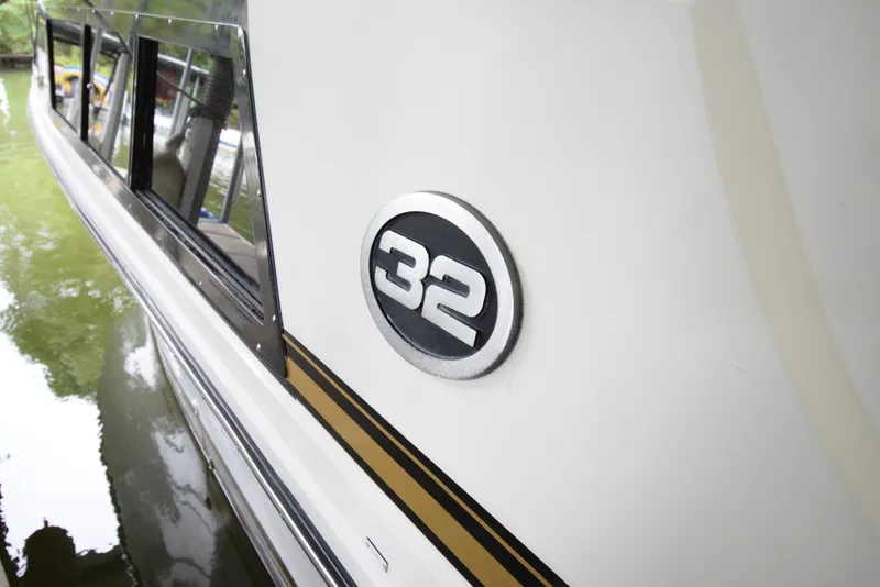 Slide: The Image of 1989 Carver 32 Mariner boat side view with "32" emblem. - 14