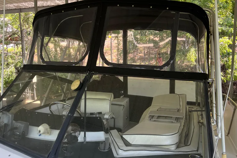 Slide: The Image of 1989 Carver 32 Mariner boat interior with helm and seating area. - 16