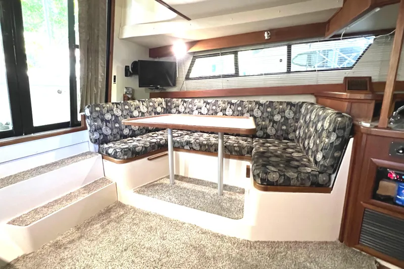 Slide: The Image of Interior of 1989 Carver 32 Mariner with cozy seating and dining area. - 17